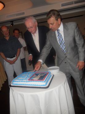 Flavin, left, cuts the cake at the show debut.