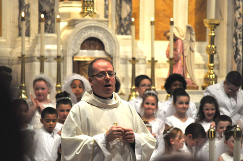 Fr. Sean Connor, pictured with a 2012 1st Communion Class at St. Ann's Church, Dorchester